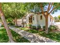 Attractive home with mature landscaping, a classic window awning, and a well-maintained sidewalk at 3030 E Camellia Dr, Gilbert, AZ 85296