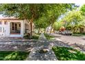 Picturesque street view featuring lush trees lining the sidewalk, highlighting the neighborhood's charm and appeal at 3030 E Camellia Dr, Gilbert, AZ 85296