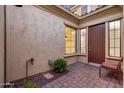 A private entrance on a brick floor with outdoor sitting area at 3467 N Hooper St, Buckeye, AZ 85396