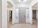 Bright foyer featuring tile flooring, a modern light fixture, and neutral paint at 3467 N Hooper St, Buckeye, AZ 85396