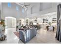 Bright open-concept living room with a gourmet kitchen and high ceilings at 3467 N Hooper St, Buckeye, AZ 85396