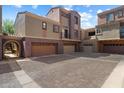Lovely townhome showing garage access, exterior finishes, and pavers at 3935 E Rough Rider Rd # 1164, Phoenix, AZ 85050