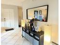 Inviting foyer showcasing decorative console table with mirror, lamps, and artwork at 4201 E Camelback Rd # 51, Phoenix, AZ 85018