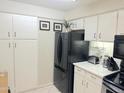 Bright kitchen with white cabinets, black appliances, and clean countertops at 4201 E Camelback Rd # 51, Phoenix, AZ 85018