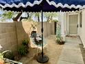 Inviting front yard with shade umbrella and charming garden decor at 4925 W Bluefield Ave, Glendale, AZ 85308