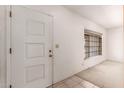 Bright entryway featuring white walls, a window, and a solid door at 548 W Linda Ln, Chandler, AZ 85225