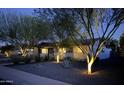 Well-lit, single story home with mature trees, xeriscaping and modern design elements creating curb appeal at 5541 E Cheery Lynn Rd, Phoenix, AZ 85018