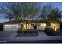 Charming single-story home with manicured front yard, cactus garden, a two-car garage, and a well lit tree at 5541 E Cheery Lynn Rd, Phoenix, AZ 85018