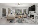 Cozy living room featuring stylish sofas, a fireplace, and large windows for natural light at 7575 E Indian Bend Rd # 1142, Scottsdale, AZ 85250