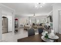 Bright living room with tile floors, comfortable seating, a fireplace, and access to the outdoors at 7575 E Indian Bend Rd # 1142, Scottsdale, AZ 85250