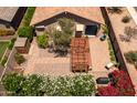 Private backyard featuring a large brick patio, pergola, shed, and mature landscaping at 7648 S Thimble Peak --, Gold Canyon, AZ 85118
