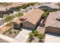 Inviting single-story home featuring a tile roof, desert landscaping, and attached two-car garage at 7648 S Thimble Peak --, Gold Canyon, AZ 85118