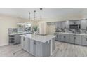 Modern kitchen featuring an island, stainless steel appliances, and sleek gray cabinetry at 11215 N 38Th N Ave, Phoenix, AZ 85029