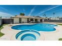 This is a backyard swimming pool and jacuzzi on a sunny day, perfect for relaxation at 11215 N 38Th N Ave, Phoenix, AZ 85029