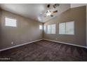 Bright bedroom with neutral walls, plush carpet, and a modern ceiling fan at 125 N 22 Pl # 14, Mesa, AZ 85213