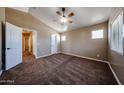 Bedroom with carpet, neutral walls, ceiling fan, and natural light from three windows at 125 N 22 Pl # 14, Mesa, AZ 85213
