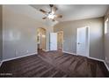 Neutral bedroom featuring carpet, vaulted ceiling, a ceiling fan, and an ensuite bathroom and closet at 125 N 22 Pl # 14, Mesa, AZ 85213