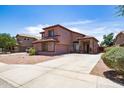 Attractive two-story home featuring a spacious driveway and desert landscaping at 13709 W Rovey Ave, Litchfield Park, AZ 85340