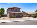 Cozy two-story home with low-maintenance desert landscaping and clean curb appeal at 13709 W Rovey Ave, Litchfield Park, AZ 85340