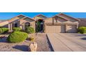 Inviting single-story home with a three-car garage and desert landscaping at 16333 E Crystal Point Dr, Fountain Hills, AZ 85268