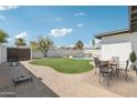 Inviting backyard features a refreshing pool, lush lawn, and outdoor dining area perfect for entertaining at 1653 E Palmcroft Dr, Tempe, AZ 85282
