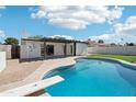 Backyard pool with diving board, patio, and well-maintained landscaping at 1653 E Palmcroft Dr, Tempe, AZ 85282