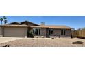 Charming single-story home boasts desert landscaping, a two-car garage, and a cozy front porch entrance at 1661 E Bishop Dr, Tempe, AZ 85282