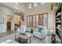 Bright living room with vaulted ceilings, large windows, and neutral furniture at 18121 W Las Cruces Dr, Goodyear, AZ 85338