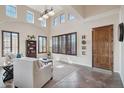 Bright living room with vaulted ceilings, large windows, and tile flooring at 18121 W Las Cruces Dr, Goodyear, AZ 85338