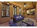 Inviting covered patio features comfortable seating, overhead lighting, and a ceiling fan for relaxation at 18121 W Las Cruces Dr, Goodyear, AZ 85338