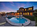 Stunning two-story home with a backyard oasis featuring a pool, spa, and covered patio area at 18121 W Las Cruces Dr, Goodyear, AZ 85338