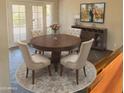 Cozy dining area with a round wooden table, elegant chairs, and stylish decor at 1838 W Enfield Way, Chandler, AZ 85286