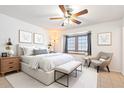 Bright bedroom featuring a ceiling fan, large window, and neutral decor at 18644 N 5Th Ave, Phoenix, AZ 85027