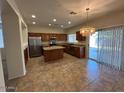 Charming kitchen with granite countertops, stainless appliances, and an island with breakfast bar at 20985 N 81St Dr, Peoria, AZ 85382