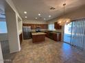 Charming kitchen with granite countertops, stainless appliances, and an island with breakfast bar at 20985 N 81St Dr, Peoria, AZ 85382