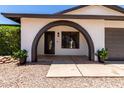 Stylish entryway featuring a unique arched entry, decorative plants, and a modern front door at 2220 S Cottonwood Dr, Tempe, AZ 85282