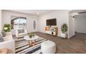 Bright living room with hardwood floors, a striped rug, and modern furniture at 2220 S Cottonwood Dr, Tempe, AZ 85282