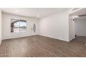 Bright living room featuring laminate flooring, fresh paint and a new front door at 2220 S Cottonwood Dr, Tempe, AZ 85282