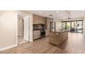 Contemporary kitchen features stainless steel appliances, gas range and a center island, flowing to an open-plan living area at 2300 E Campbell Ave # 114, Phoenix, AZ 85016