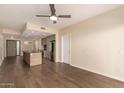 Open living room with stainless steel appliances and a large island, seamlessly flowing to a well-lit living area at 2300 E Campbell Ave # 114, Phoenix, AZ 85016