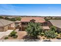 Two-story home featuring a balcony, a three-car garage, and well-maintained landscaping at 23081 S 223Rd Way, Queen Creek, AZ 85142