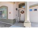 Inviting front entrance with a decorative wreath and 'Home Sweet Home' doormat at 23645 W Parkway Dr, Buckeye, AZ 85326