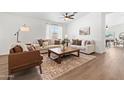 Bright living room featuring stylish furniture, wood floors, and ample natural light at 23645 W Parkway Dr, Buckeye, AZ 85326