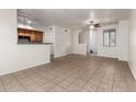 Open-concept living room showcases tile floors, a ceiling fan, and a breakfast bar for versatile living and entertaining at 2402 E 5Th St # 1411, Tempe, AZ 85288