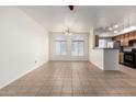 Open living area features tile flooring, modern lighting, and flows seamlessly into the kitchen, perfect for entertaining guests at 2402 E 5Th St # 1411, Tempe, AZ 85288