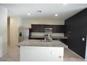Kitchen featuring stainless steel appliances, granite countertops, island and dark cabinets at 24646 N Barley Rd, Florence, AZ 85132