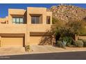 Desert home features a two-car garage and well-maintained landscaping with desert plants at 25555 N Windy Walk Dr # 34, Scottsdale, AZ 85255