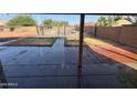 View of the backyard with pool from the covered patio at 2634 S 63Rd Dr, Phoenix, AZ 85043