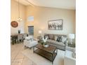 Bright living room featuring a modern sofa set, neutral paint and ample lighting at 2634 S 63Rd Dr, Phoenix, AZ 85043