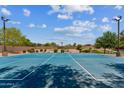 Full-sized outdoor basketball court with bright blue surface and professional lighting at 277 E Kaibab Dr, Chandler, AZ 85249